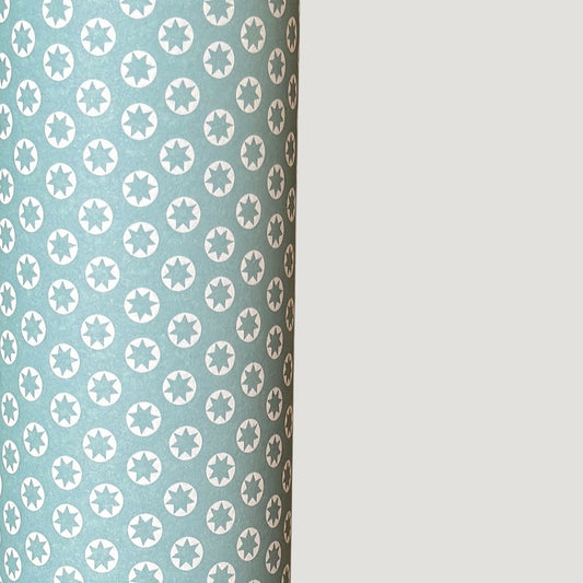 wrapping paper with an abstract tiny stars pattern in ice blue and white by Ola Studio