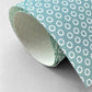 wrapping paper with an abstract tiny stars pattern in ice blue and white by Ola Studio