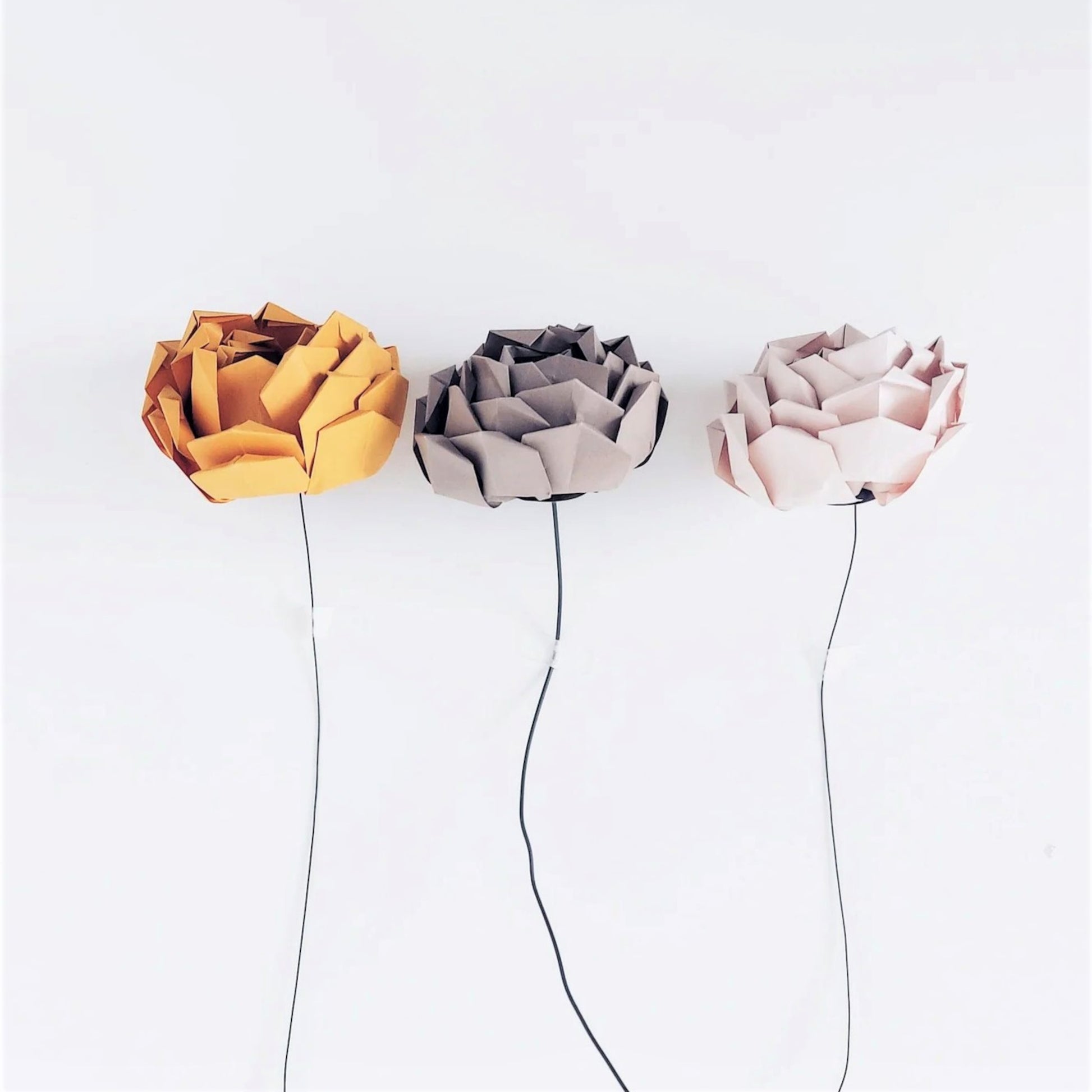 Three paper peonies, in mustard yellow, taupe and pale pink, made from a paper craft kit, by Origami Est