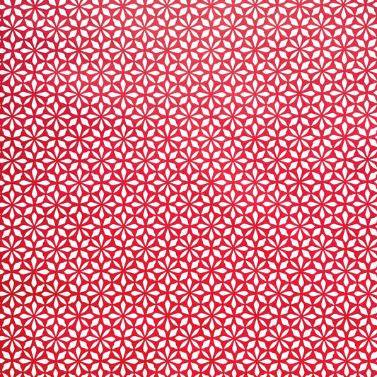 wrapping paper by Otto Editions with a cut-out flower design in white on a magenta pink background. 