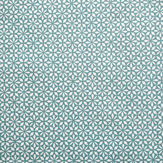 wrapping paper by Otto Editions with a cut-out flower design in white on an aqua blue background. 
