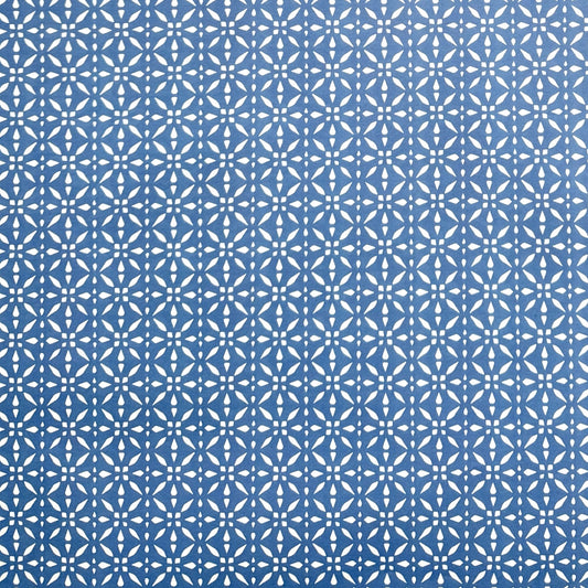 wrapping paper by Otto Editions with a cut-out design in white on a sky blue background. 