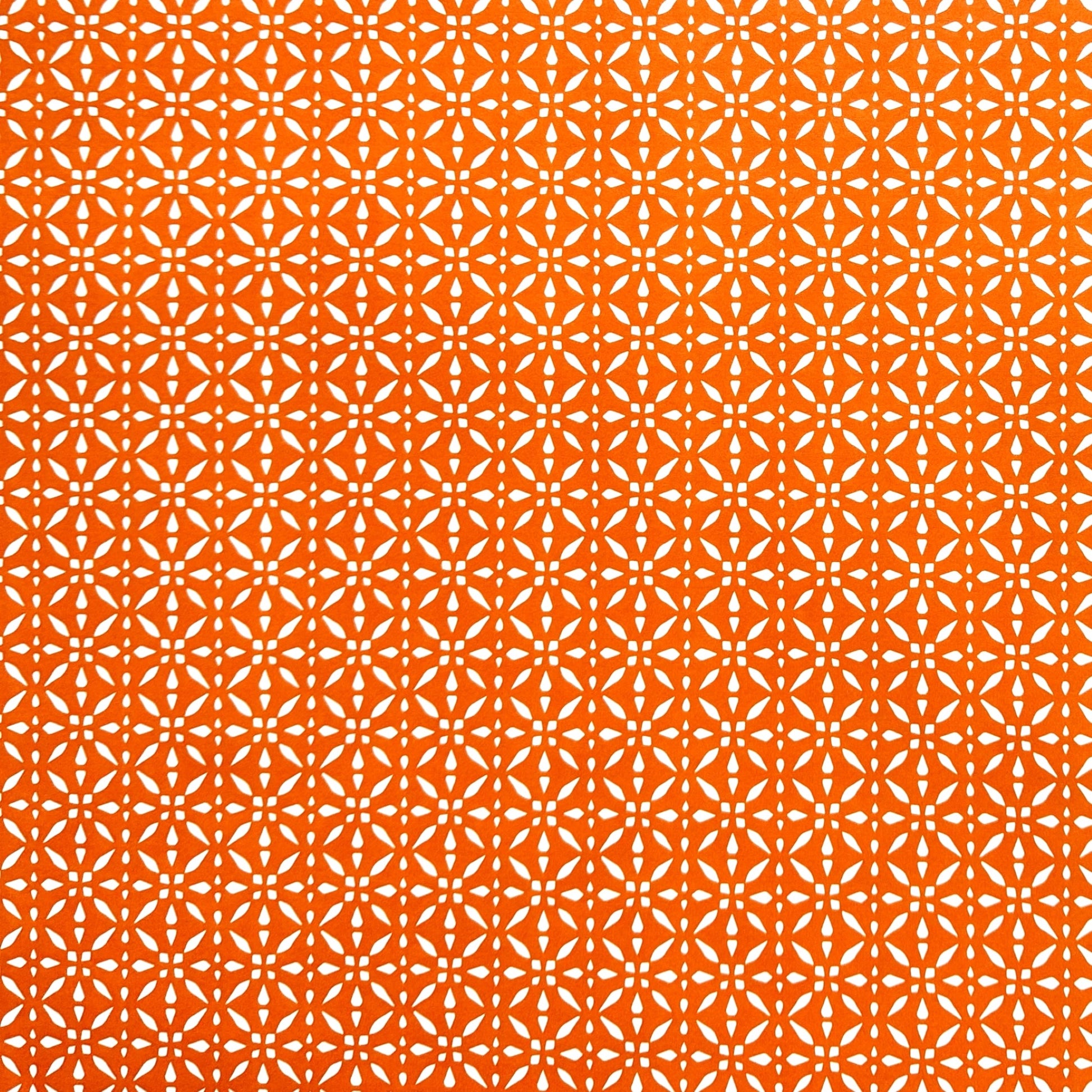 wrapping paper by Otto Editions with a cut-out design in white on a spice orange background. 