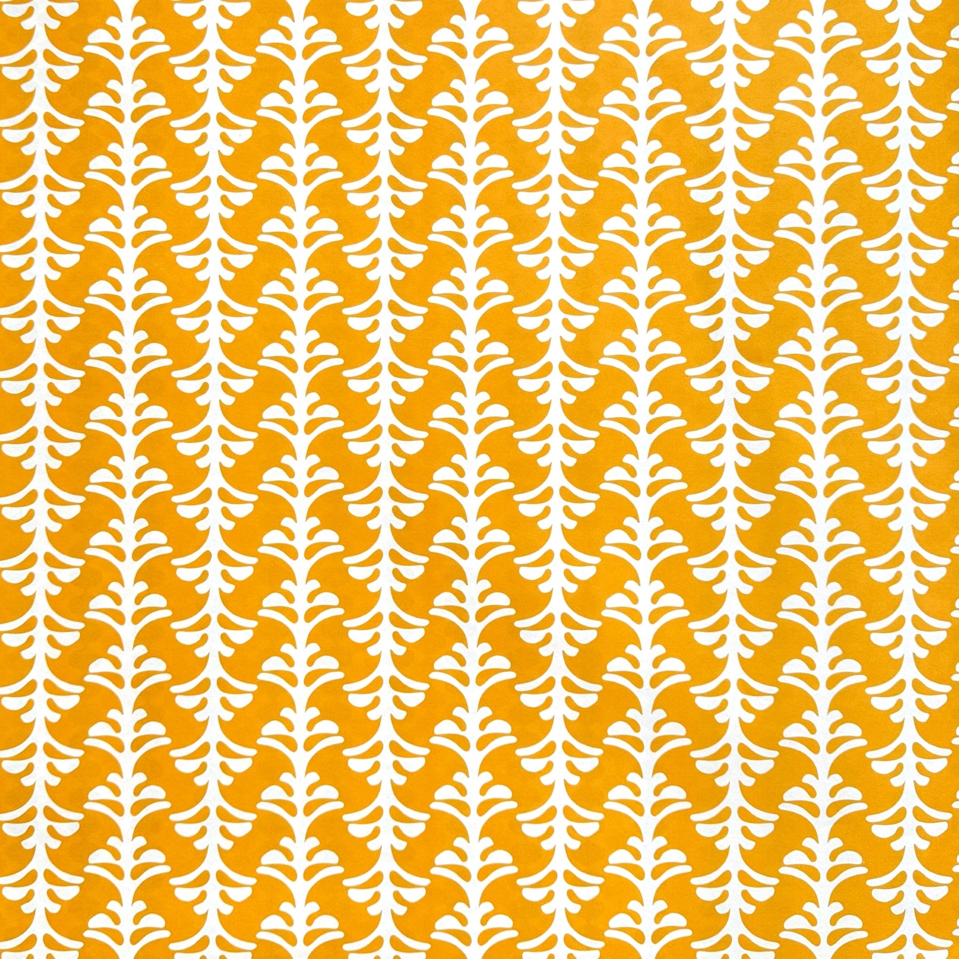wrapping paper by Otto Editions with a cut-out palm design in white on a saffron yellow background. 