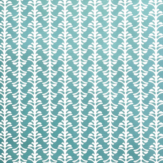 wrapping paper by Otto Editions with a cut-out palm design in white on an aqua blue background. 