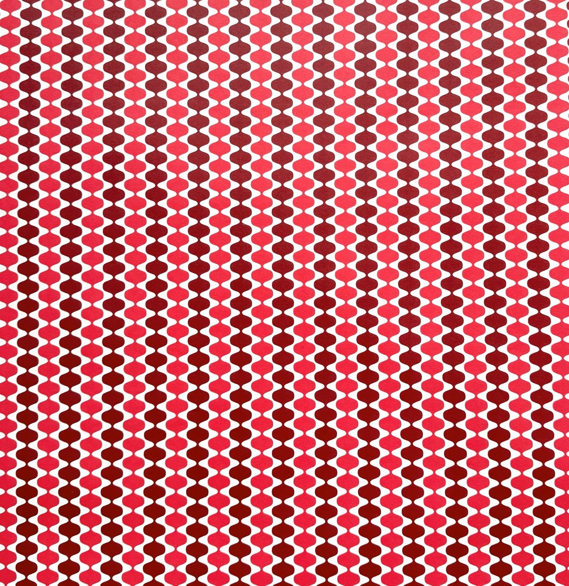 wrapping paper by Otto Editions with a cut-out wavy design in white on a pink and burgundy background. 