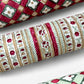 Hand block printed wrapping paper with a striped design in red, green and gold. Close up