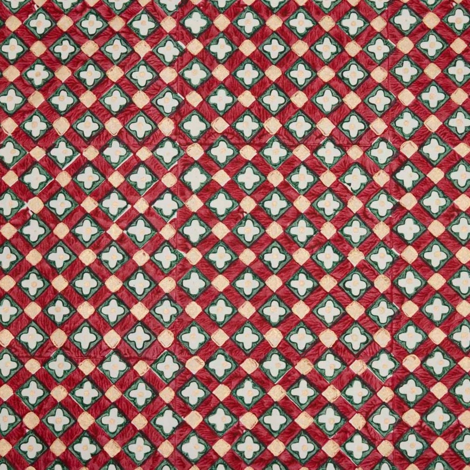Hand block printed wrapping paper with a floral checked pattern in red, green and gold.