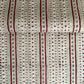 Hand block printed wrapping paper with a striped design in red, green and gold. 