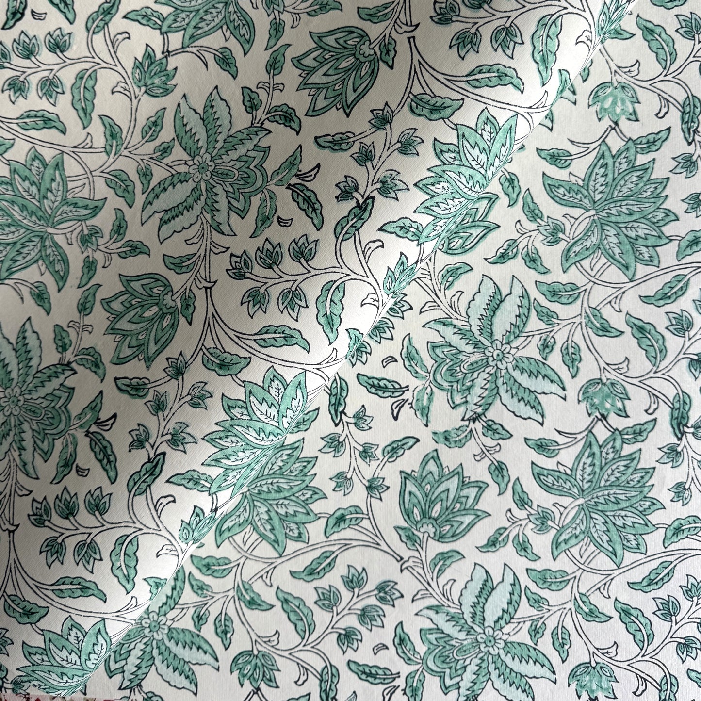 wrapping paper with repeat botanical floral pattern in light aqua by Paper Mirchi