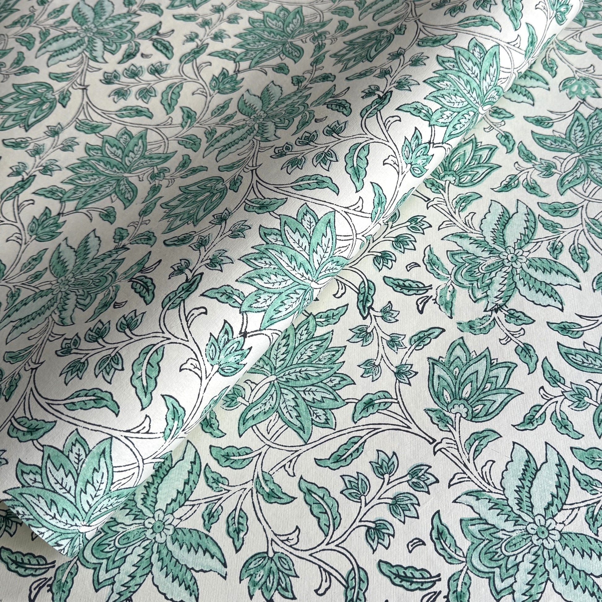wrapping paper with repeat botanical floral pattern in light aqua by Paper Mirchi