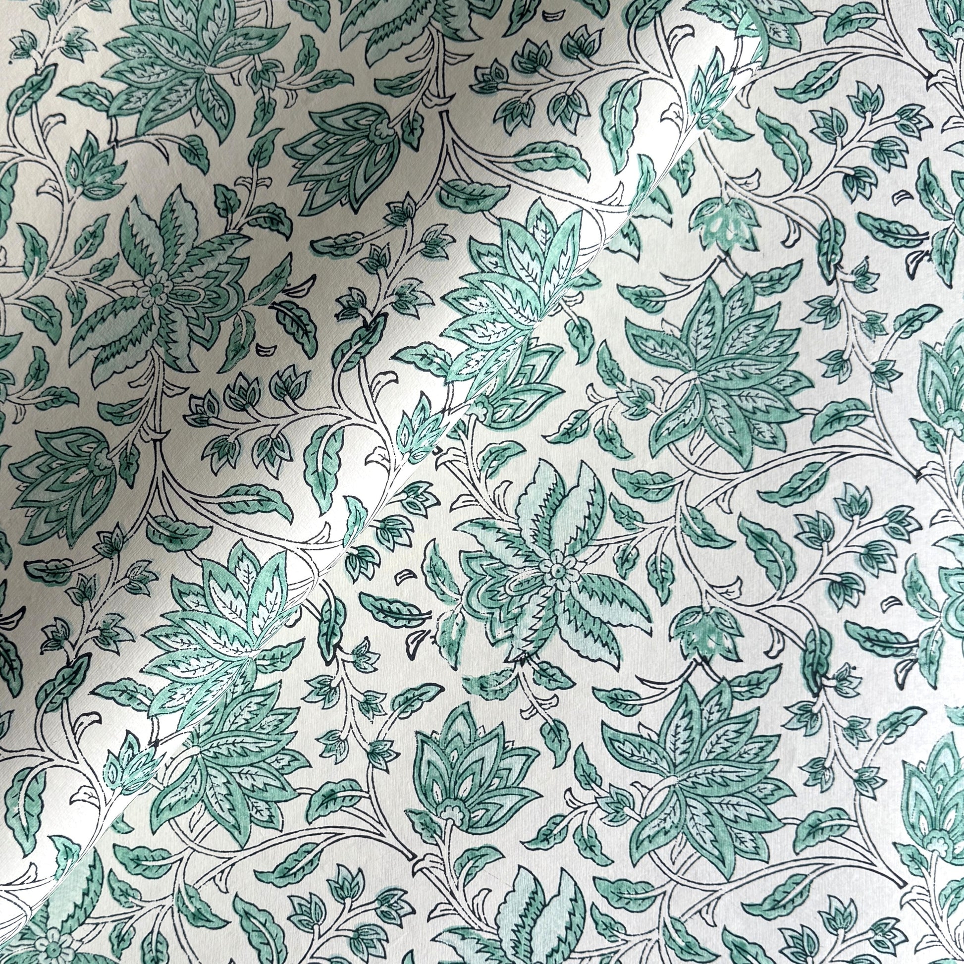 wrapping paper with repeat botanical floral pattern in light aqua by Paper Mirchi