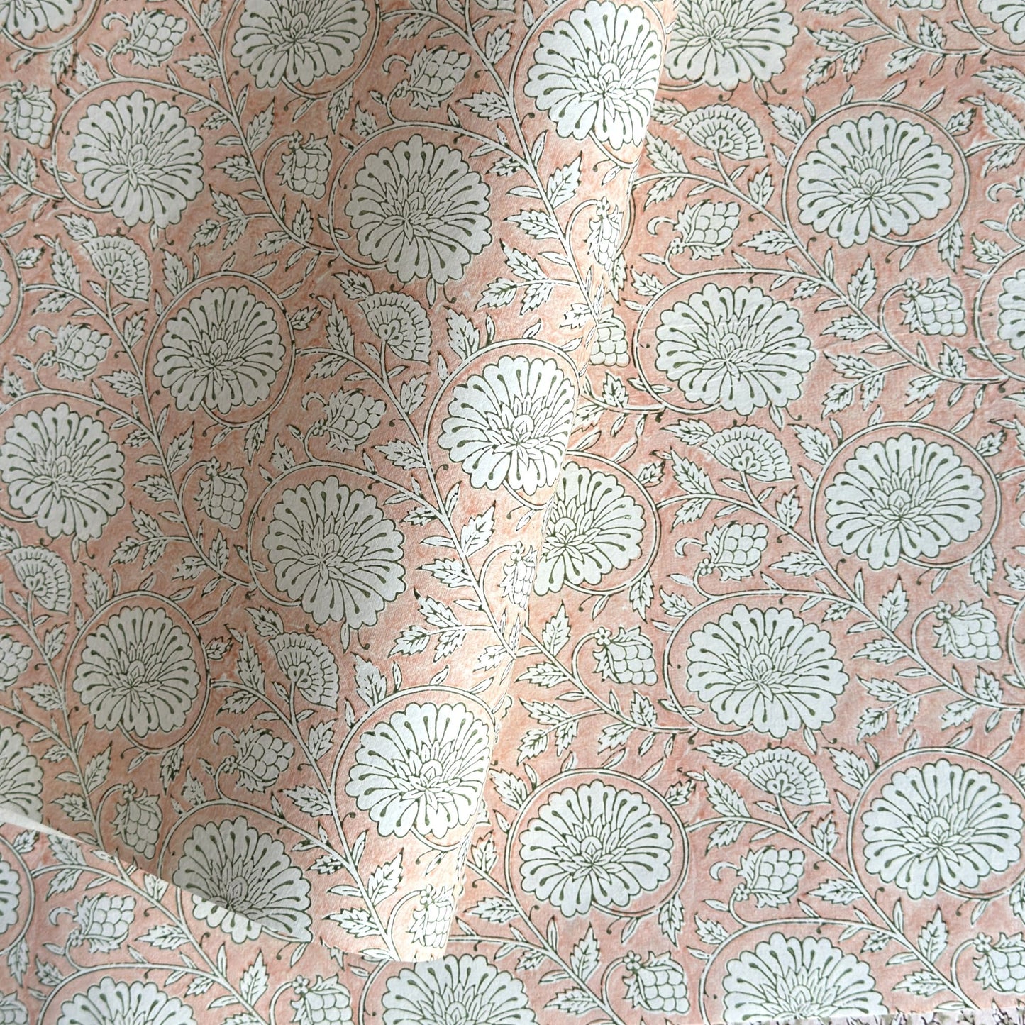 wrapping paper with repeat botanical pattern in light coral pink by Paper Mirchi