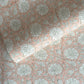 wrapping paper with repeat botanical pattern in light coral pink by Paper Mirchi