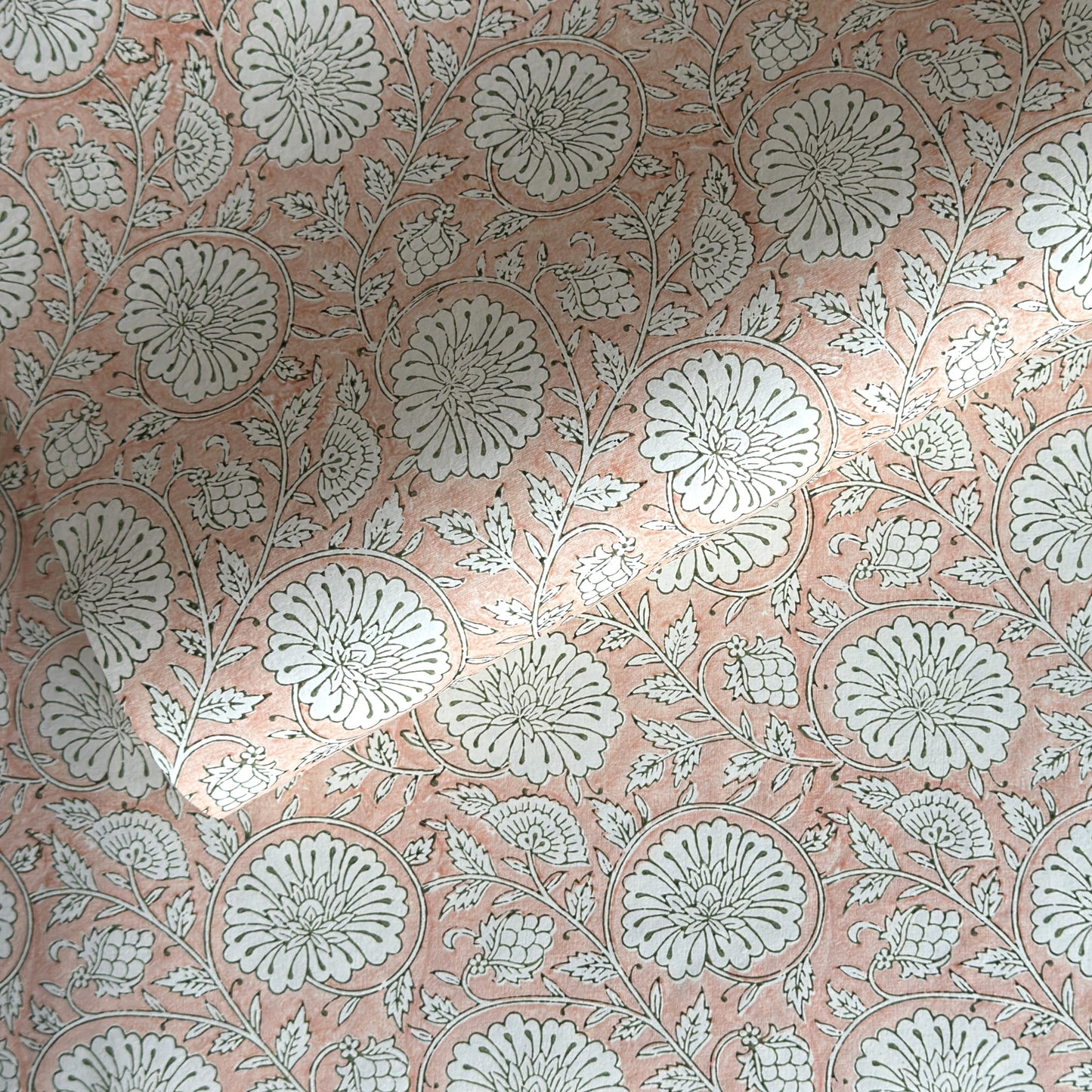 wrapping paper with repeat botanical pattern in light coral pink by Paper Mirchi