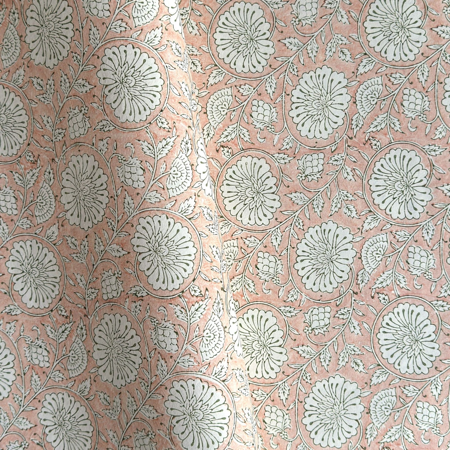 wrapping paper with repeat botanical pattern in light coral pink by Paper Mirchi
