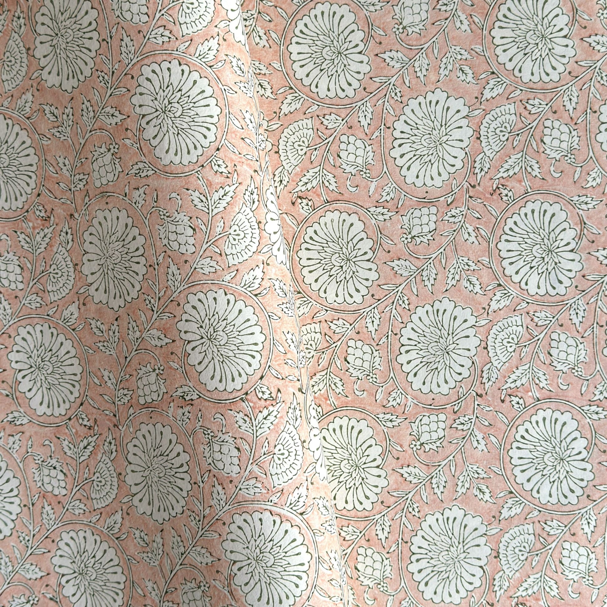 wrapping paper with repeat botanical pattern in light coral pink by Paper Mirchi