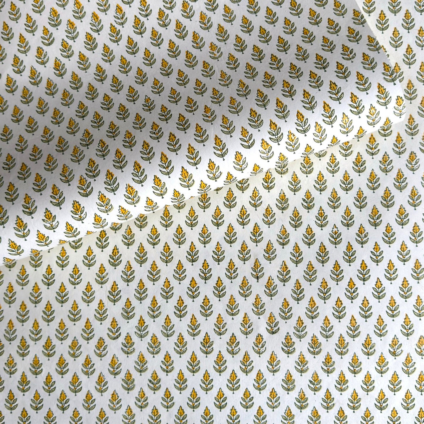 Wrapping paper with block print small flower motif in yellow and green, white background by Paper Mirchi