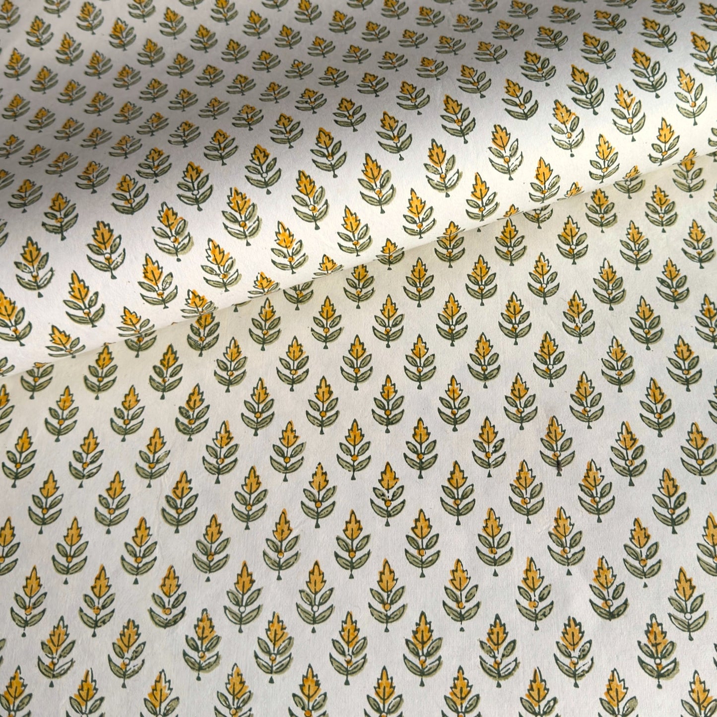 Wrapping paper with block print small flower motif in yellow and green, white background by Paper Mirchi