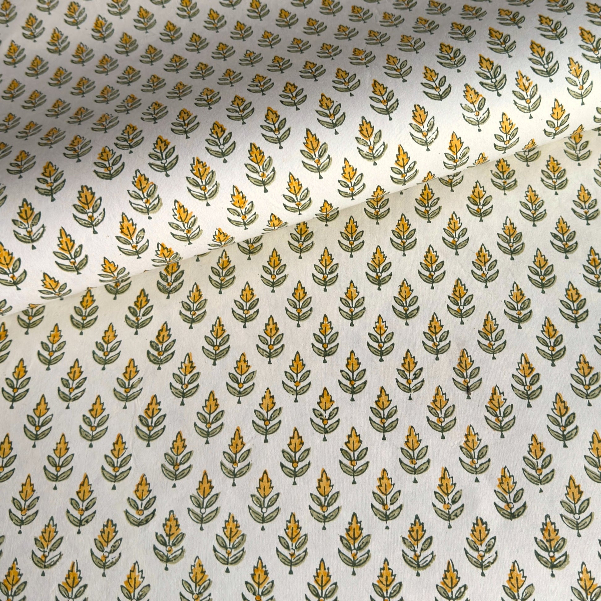 Wrapping paper with block print small flower motif in yellow and green, white background by Paper Mirchi