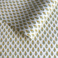 Wrapping paper with block print small flower motif in yellow and green, white background by Paper Mirchi