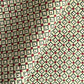 Hand block printed wrapping paper with a floral checked pattern in sage green and red.