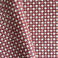 Hand block printed wrapping paper with a floral checked pattern in red, green and gold.