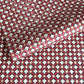 Hand block printed wrapping paper with a floral checked pattern in red, green and gold.