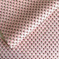 hand block printed patterned paper by Paper Mirchi, red daisy print on pink background