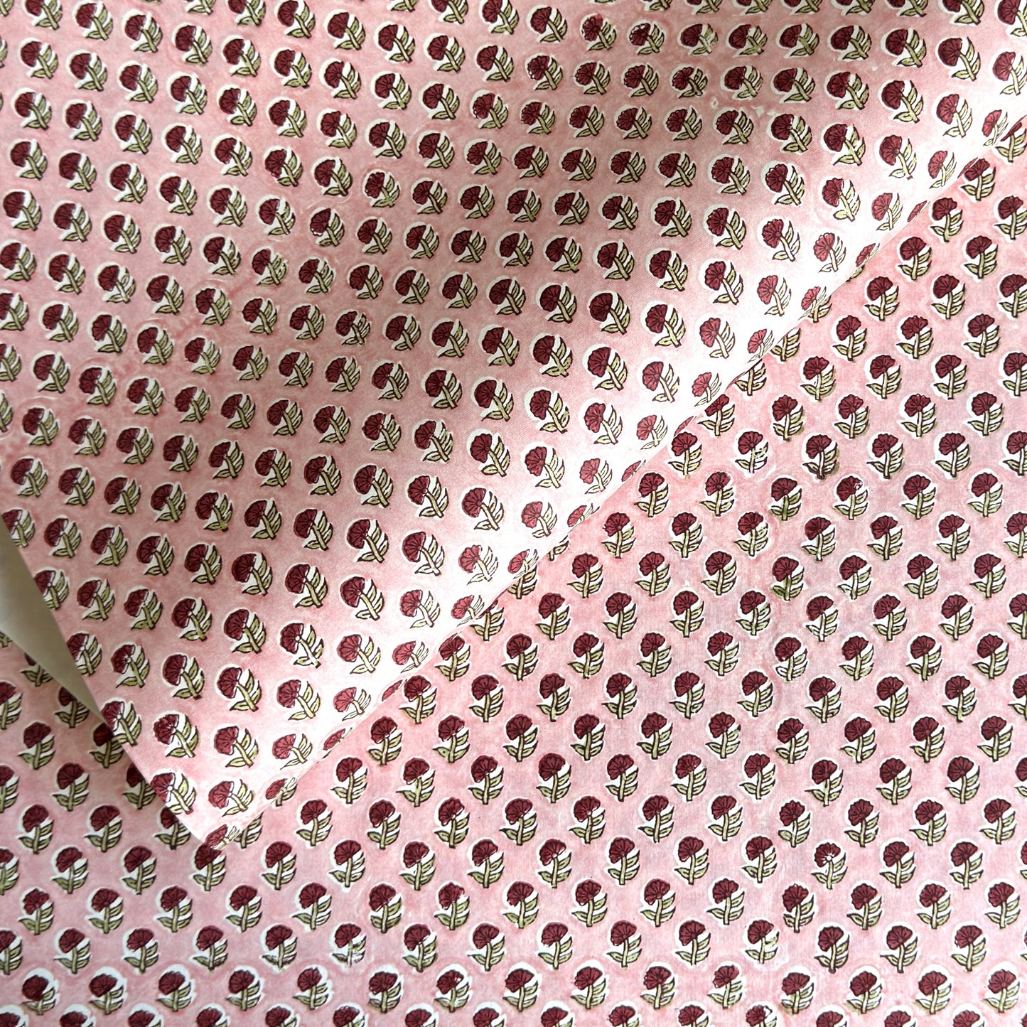 hand block printed patterned paper by Paper Mirchi, red daisy print on pink background