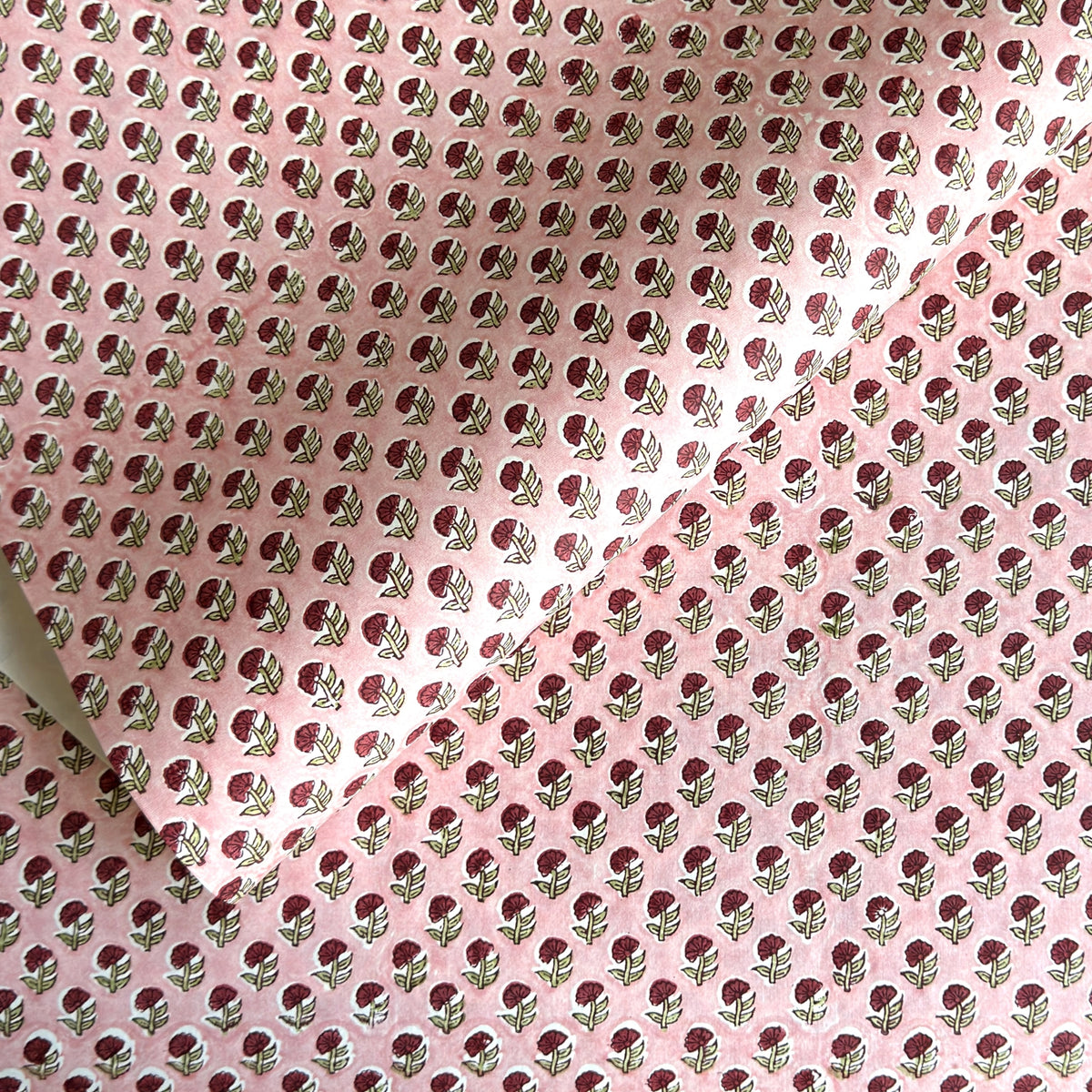 hand block printed patterned paper by Paper Mirchi, red daisy print on pink background