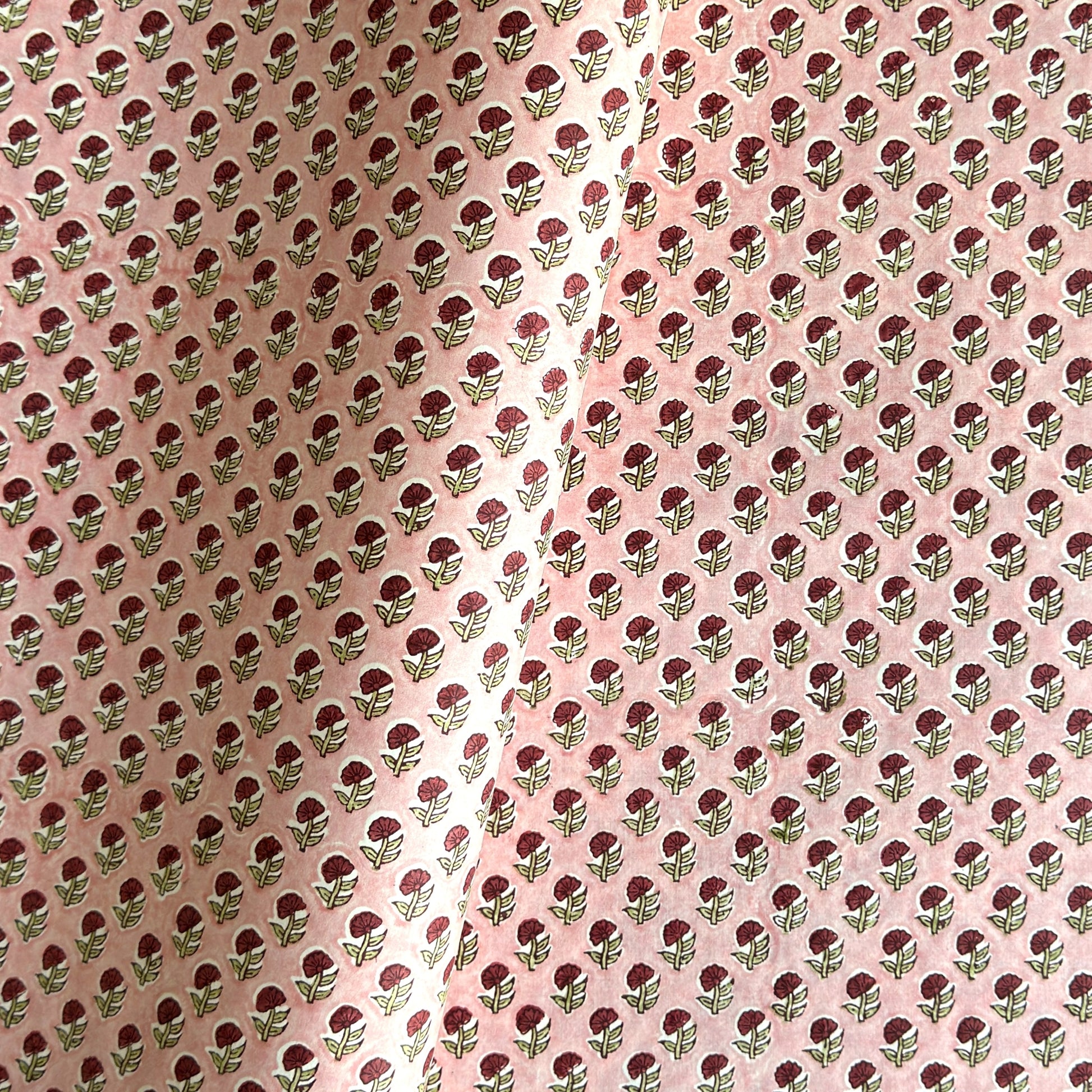 hand block printed patterned paper by Paper Mirchi, red daisy print on pink background
