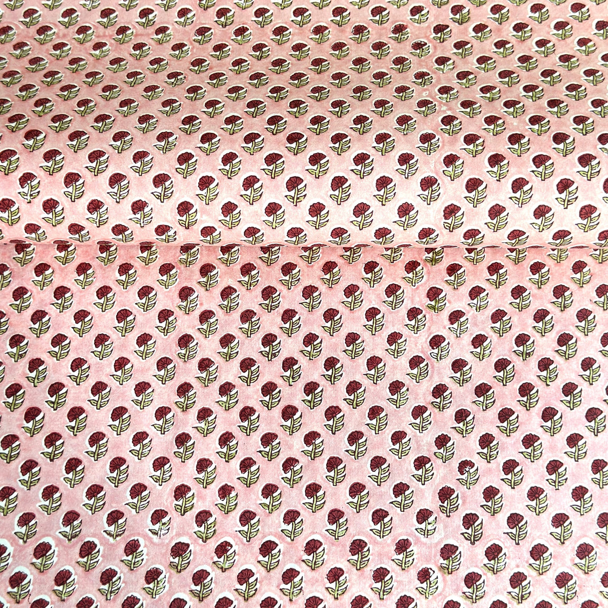 hand block printed patterned paper by Paper Mirchi, red daisy print on pink background