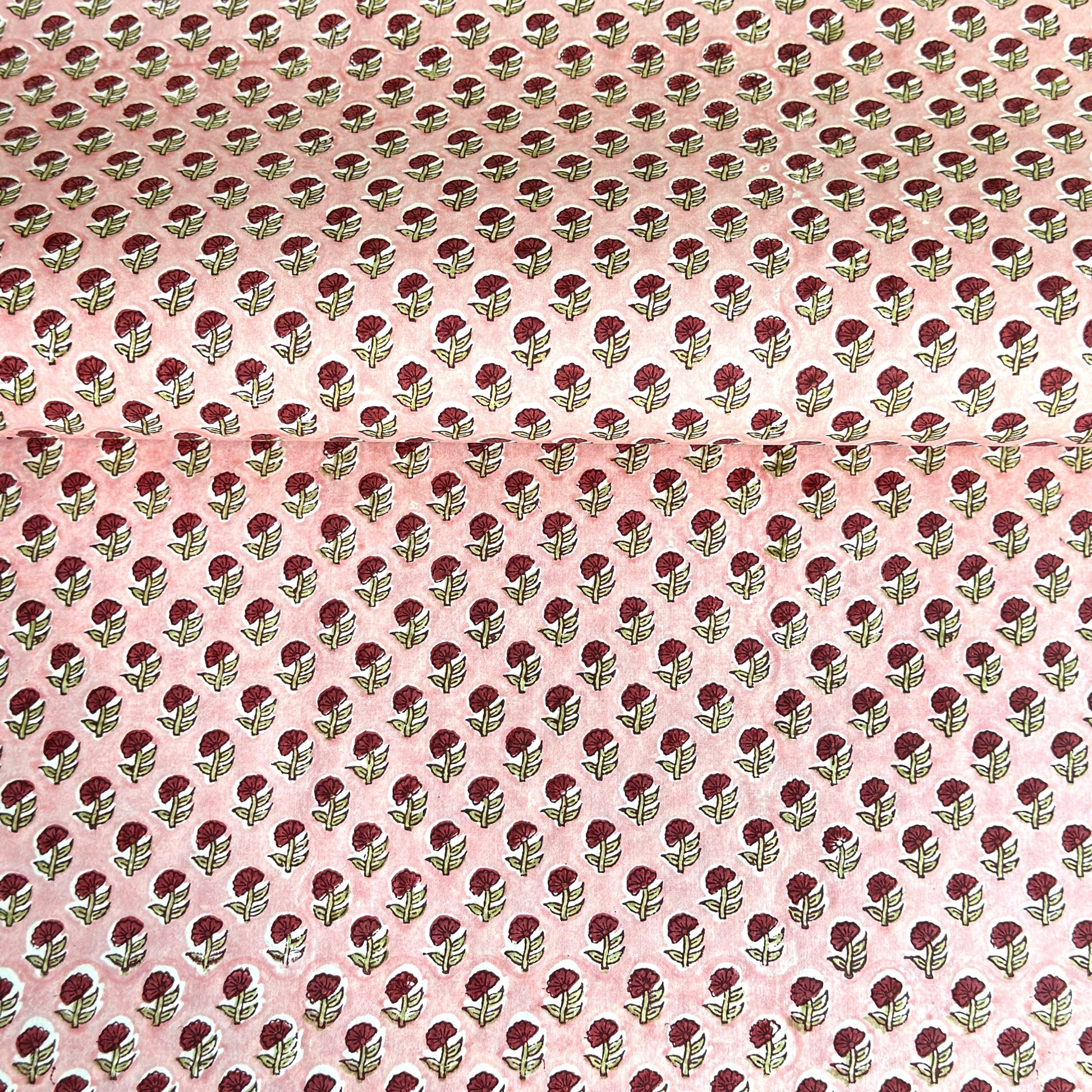 hand block printed patterned paper by Paper Mirchi, red daisy print on pink background