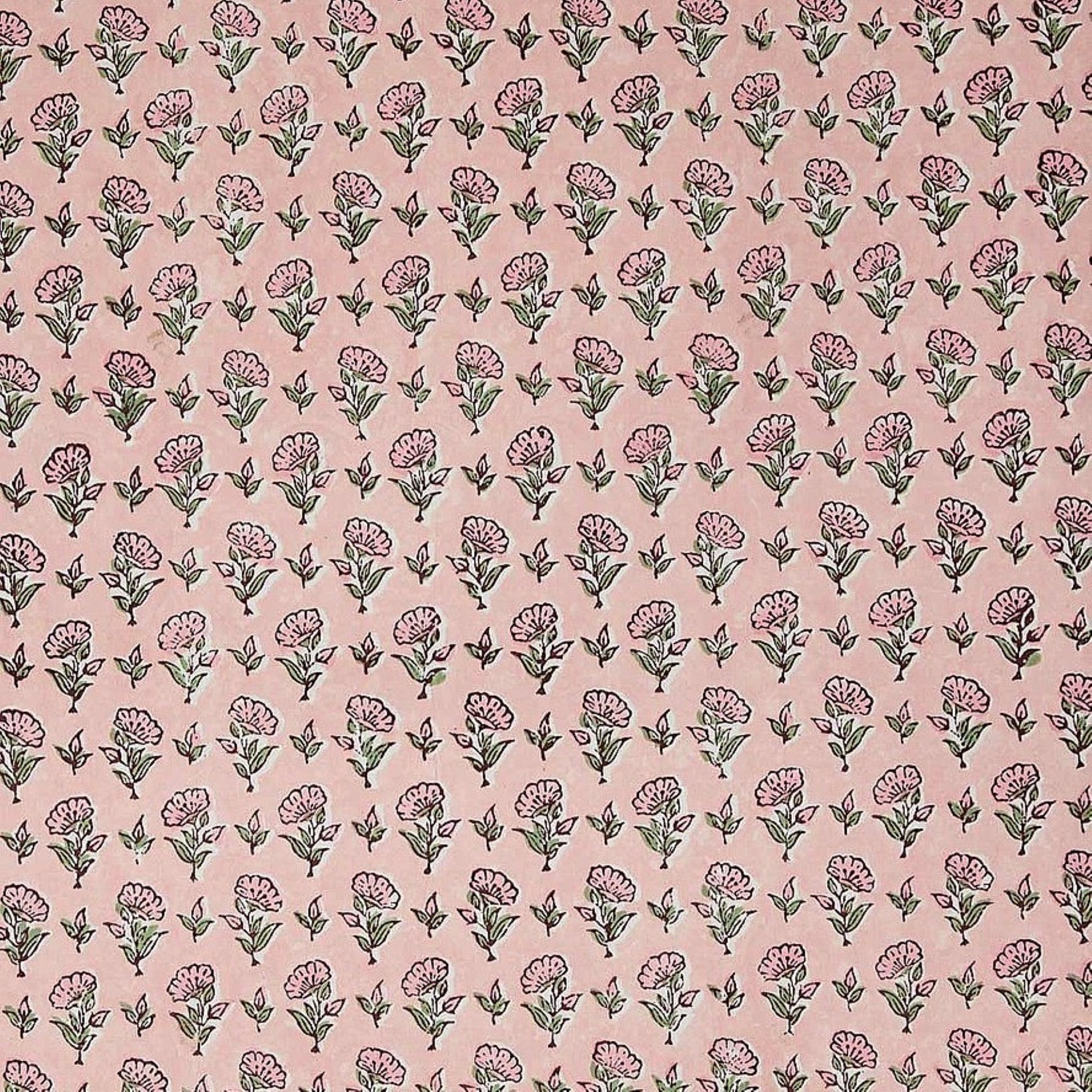 a hand block printed sheet of wrapping paper with a ditsy floral print in pink