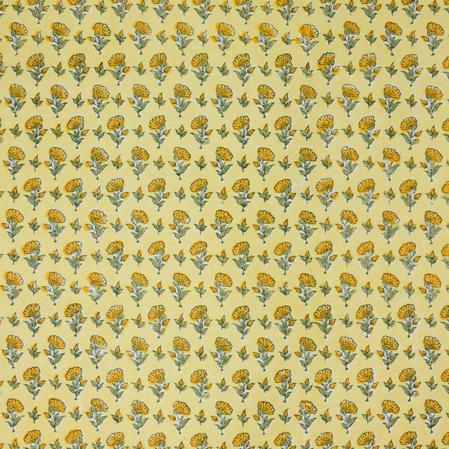 a sheet of hand block printed wrapping paper with a ditsy floral flower design in yellow