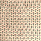 a hand block printed sheet of wrapping paper with a ditsy floral print in pink. Pictured rolled with another design