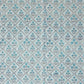 a sheet of hand block printed wrapping paper with a floral lattice design in soft blue