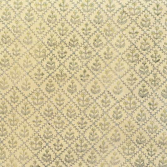 a sheet of hand block printed wrapping paper with a floral lattice design in soft buttermilk yellow