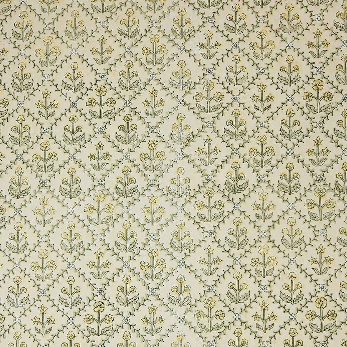 a sheet of hand block printed wrapping paper with a floral lattice design in soft buttermilk yellow