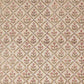 a sheet of hand block printed wrapping paper with a floral trellis design in coral pink and sage green