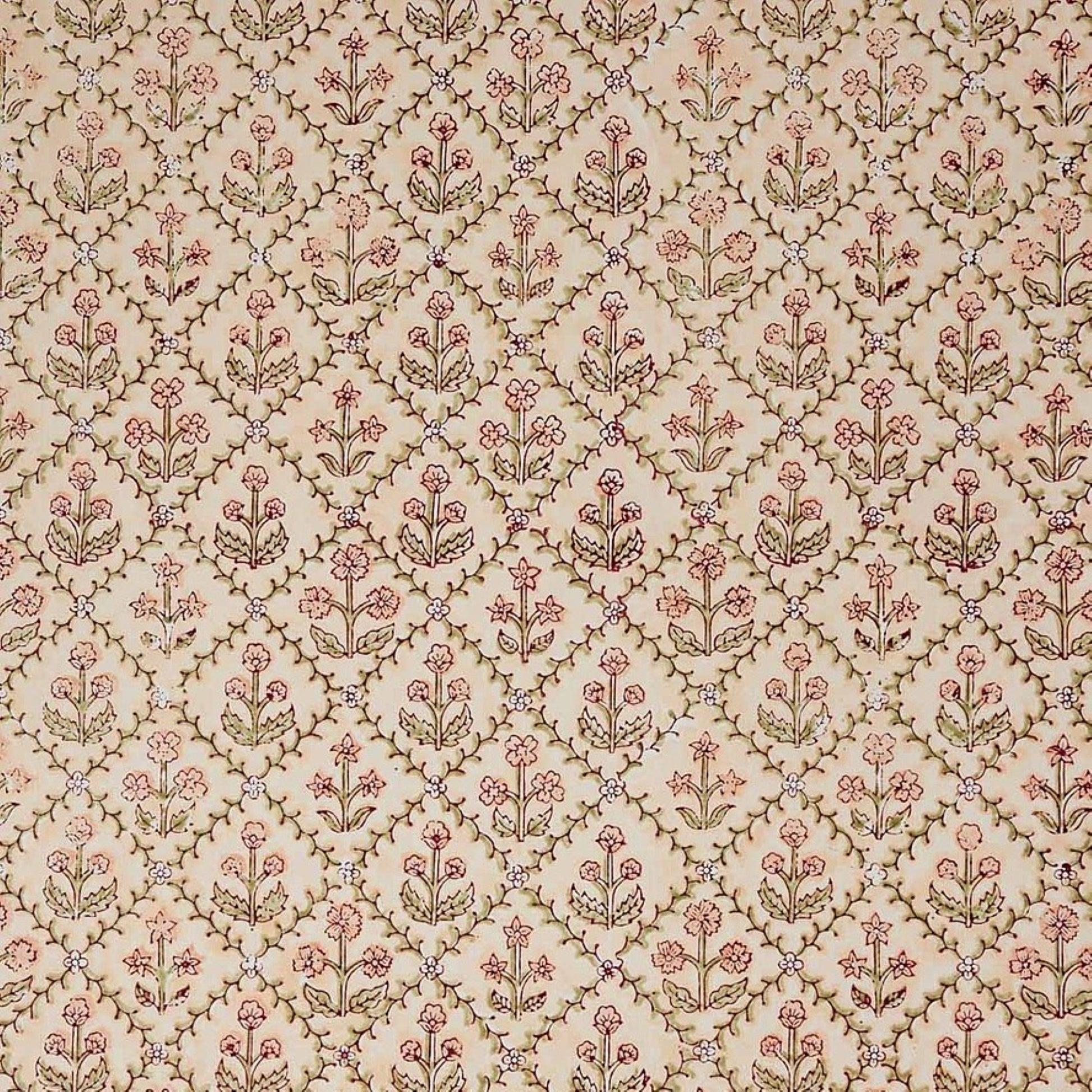 a sheet of hand block printed wrapping paper with a floral trellis design in coral pink and sage green