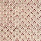 a sheet of hand block printed paper with a floral trellis design in blush pink, sage green and deep red