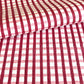 red and pink gingham pattern hand block printed on a white sheet of cotton paper