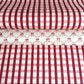 red and pink gingham pattern hand block printed on a white sheet of cotton paper. Pictured with another paper that has pink bows