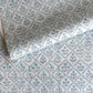 a sheet of hand block printed wrapping paper with a floral lattice design in soft blue