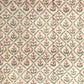 a sheet of hand block printed wrapping paper with a floral trellis design in coral pink and sage green