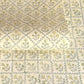a sheet of hand block printed wrapping paper with a floral lattice design in soft buttermilk yellow