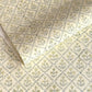 a sheet of hand block printed wrapping paper with a floral lattice design in soft buttermilk yellow