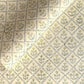 a sheet of hand block printed wrapping paper with a floral lattice design in soft buttermilk yellow